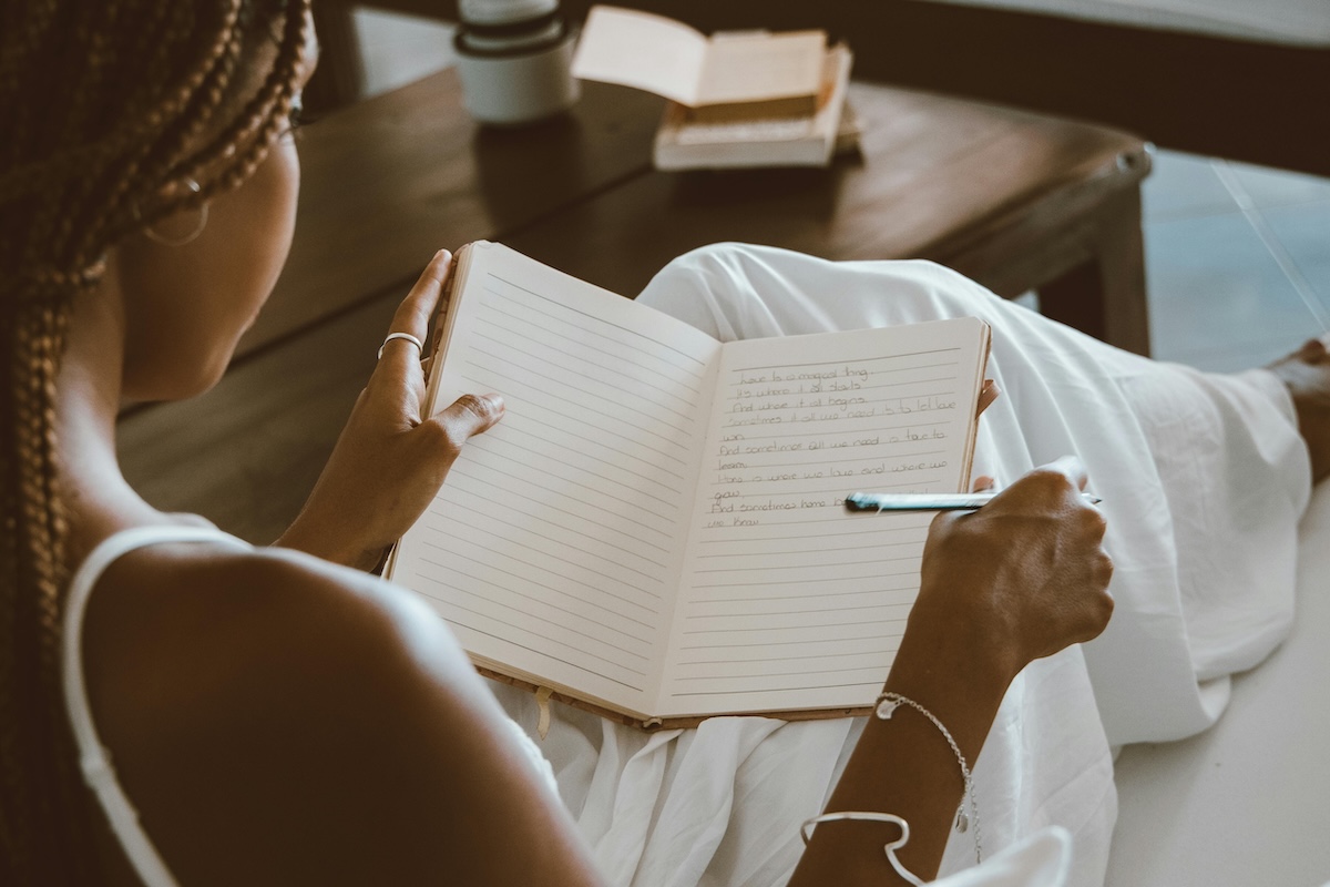 image of woman reflecting on her journal entries