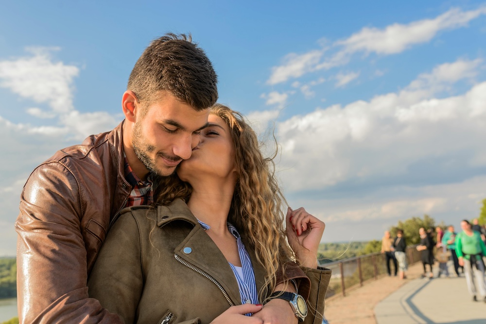 A happy couple sharing a fun, warm embrace, symbolizing renewed intimacy and a healthy relationship after recovery from pornography addiction.