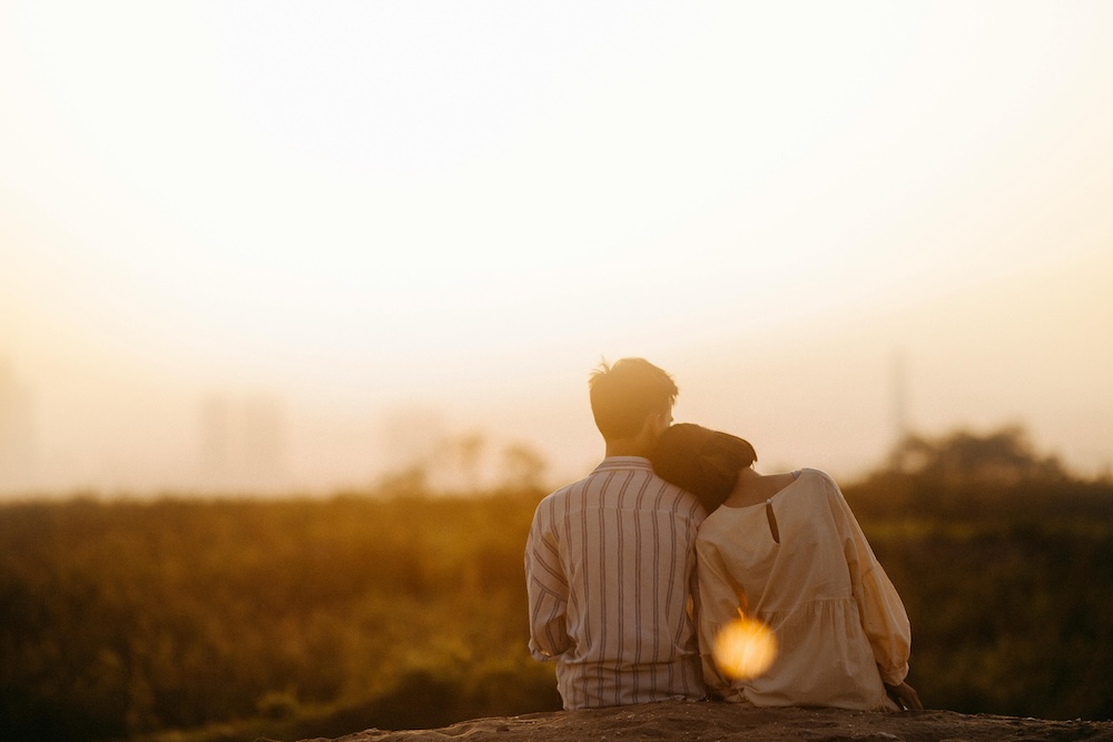 A happily married couple shares a quiet, serene embrace in the evening, symbolizing long-term relationship happiness and a hopeful, secure future together.
