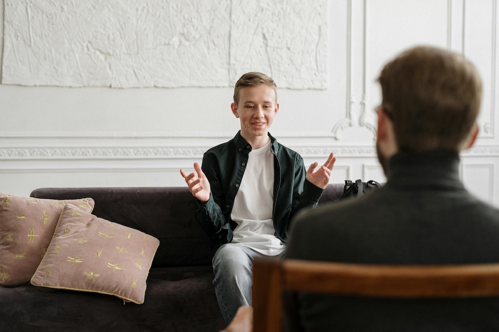 A young man receiving professional counseling from an experienced therapist, highlighting the importance of seeking help to manage pornography withdrawal symptoms and navigate the recovery journey.