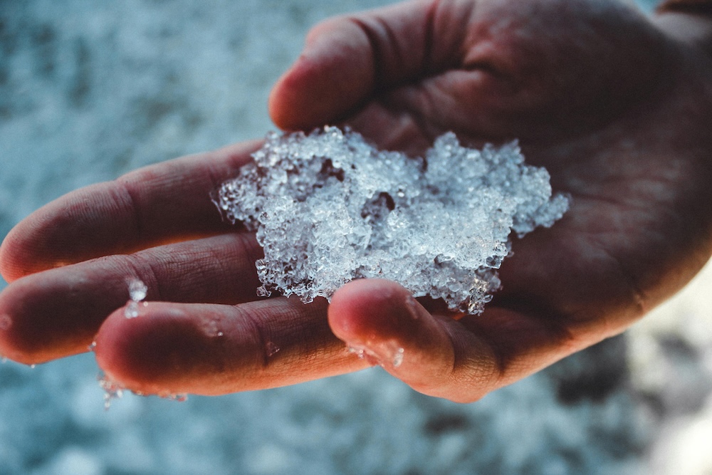 A close-up of someone using ice to regulate their nervous system, a practical tool for breaking the urge to contact an abuser.