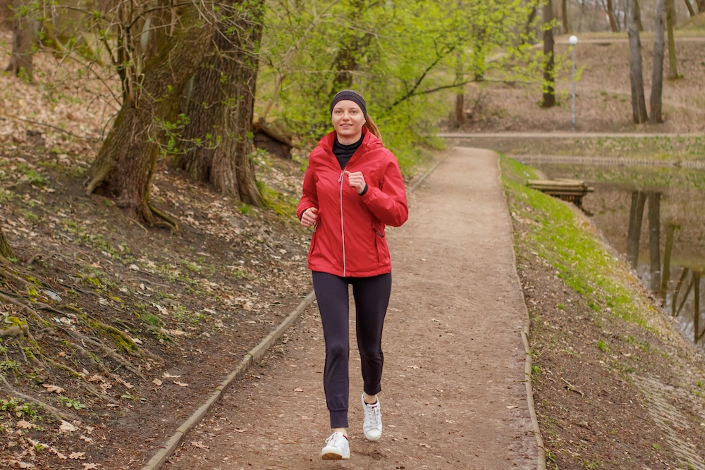 A woman engaging in running, a self-care activity, representing the shift from monitoring a partner to investing in one’s own well-being.