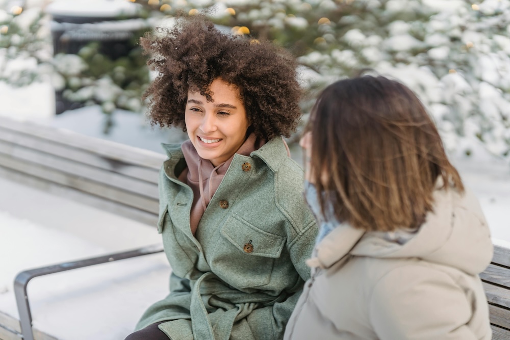 A woman engaging in a supportive conversation with a compassionate therapist.