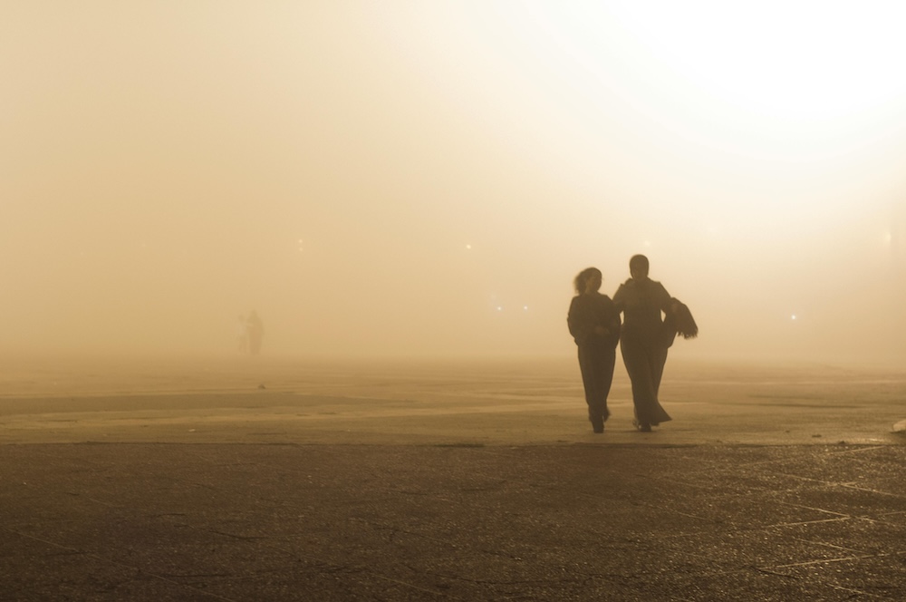 Couple walking out of the fog, representing the hope and clarity found in betrayal trauma recovery.