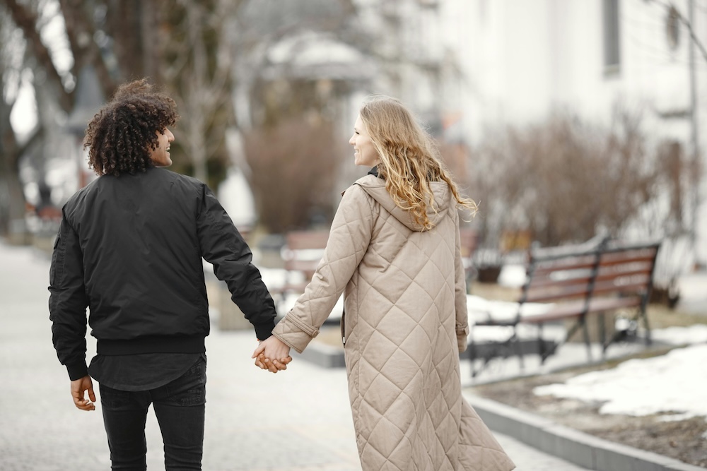 A couple walking side-by-side outdoors, symbolizing the ongoing journey and long-term commitment to a healthy, intimate marriage.