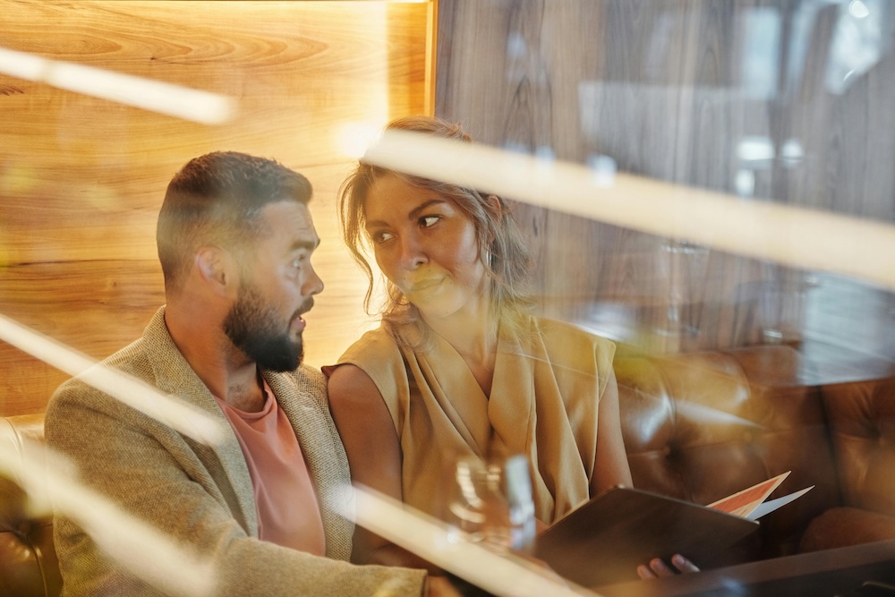 A couple engaged in a deep, curious conversation, practicing Gottman Love Maps to rebuild their emotional connection.