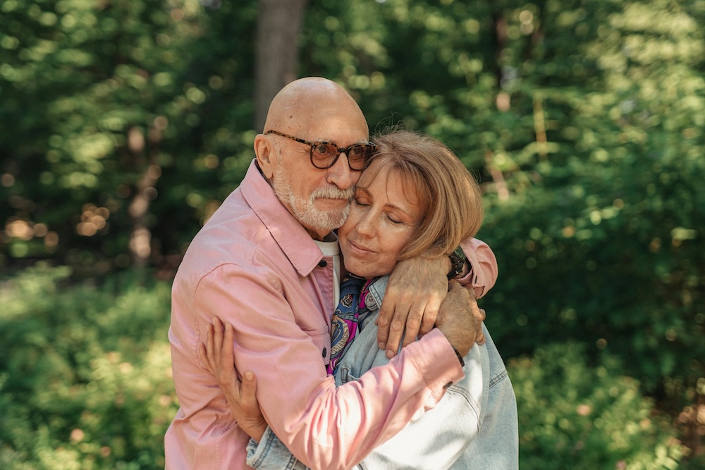 A couple sharing a meaningful, long hug to release oxytocin and strengthen their emotional bond.