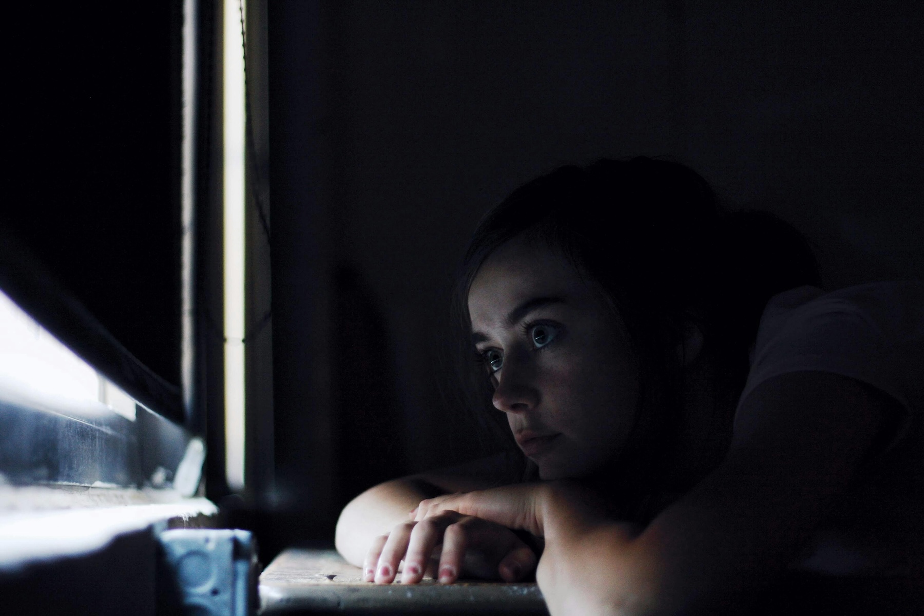 polyvagal techniques for betrayal trauma, woman sitting quietly by a window in evening light
