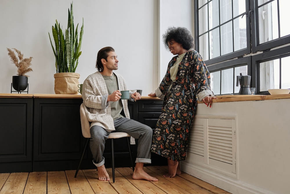 Two people in a quiet conversation in morning light — the long arc of relational repair after betrayal