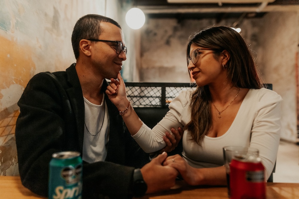 Porn induced erectile dysfunction recovery — a couple sitting close, talking quietly in soft evening light.