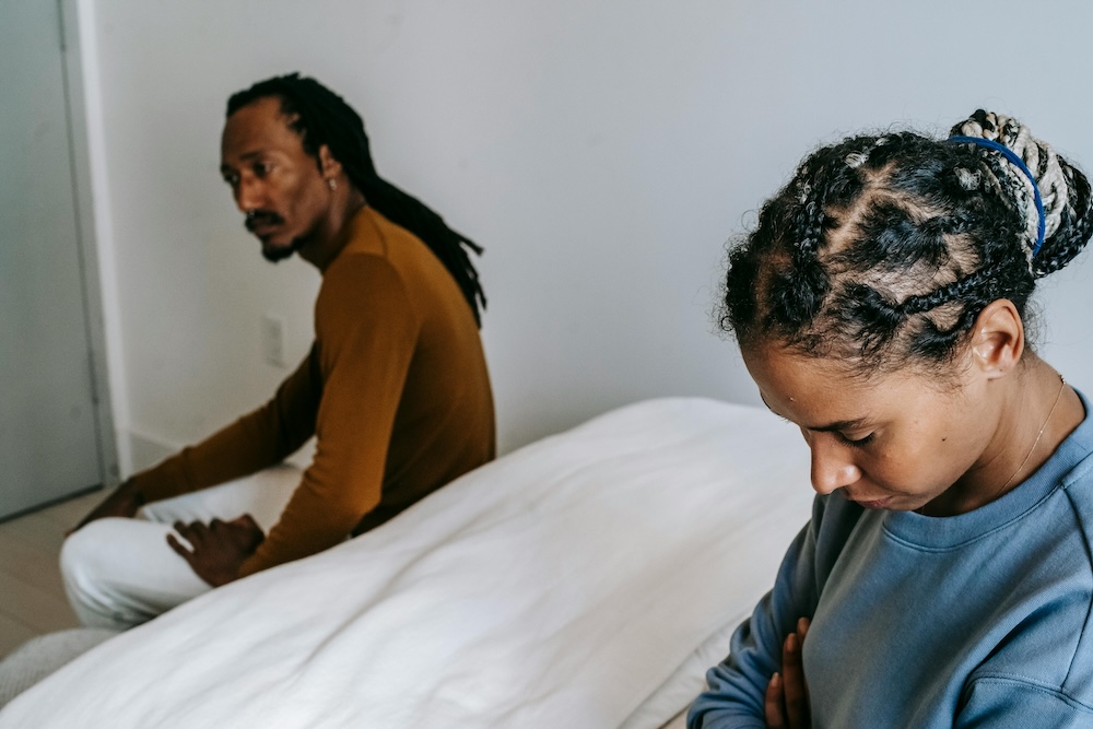Couple sitting apart, the difficult conversation between betrayed partner and partner who has been disclosing in pieces