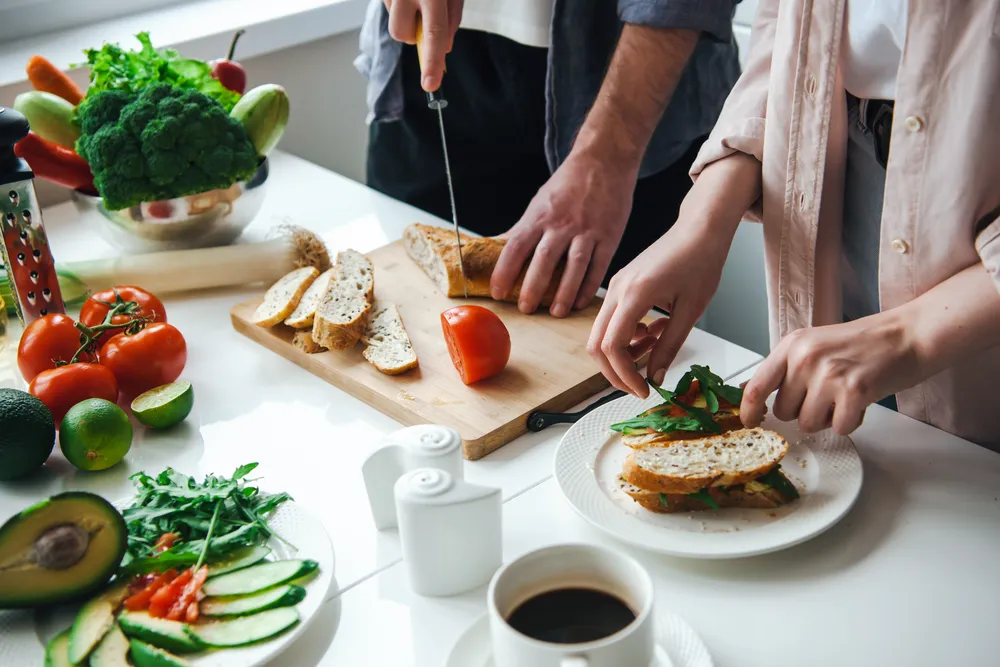 Couple's hands preparing a fresh home-cooked meal together, real nourishment and connection