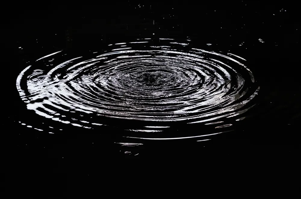 Ripples still spreading on water after the stone has sunk, illustrating why betrayal trauma symptoms persist